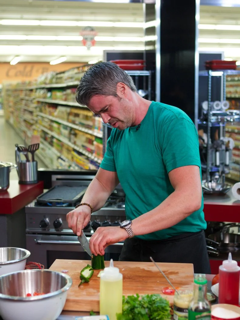 Chef Marcel Cocit during the cooking part of Game 2, Grocery List, Mexican Fiesta, Ad Sale integration Kikkoman Soy Sauce, must have Kikkoman Soy Sauce, 30 minute time limit, as seen on Food Network's Guy's Grocery Games, Season 1.