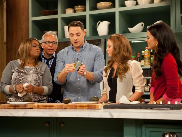 Jeff Mauro demonstrates an avocado dicer before cast members compete in a gadgets competition as seen on Food Network's The Kitchen, Season 1.