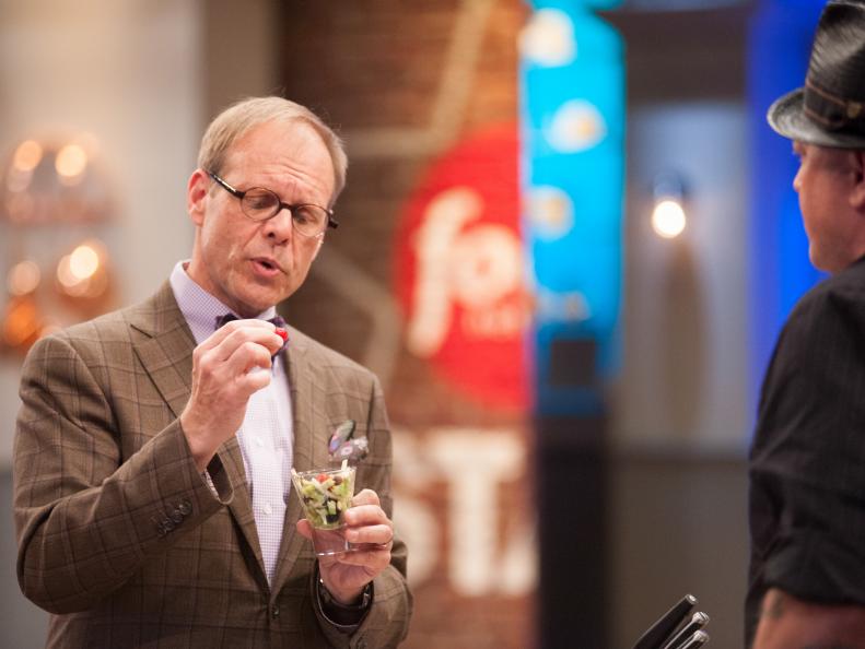 Finalist Rodney Henry presenting their dish to Mentor Alton Brown for the Mentor's Challenge "Mystery Bag" as seen on Food Network Star, Season 9.