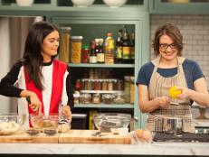 Pastry chef Jenny McCoy, right, prepares Chocolate Dried Cherry Bread Pudding with the help of host Katie Lee, left, as seen on Food Network's The Kitchen, Season 1.