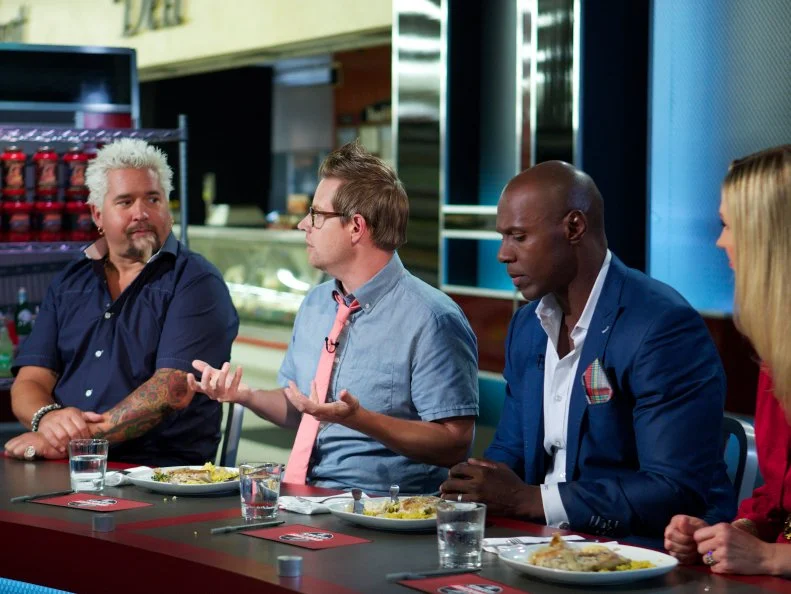 Host Guy Fieri with judges Richard Blais, DC Crenshaw, and Catherine McCord during the judging of Game 3, 5 Ingredients Or Less, Upscale Chicken Dinner, 35 min cooking time, with judges Richard Blais, DC Crenshaw, and Catherine McCord, as seen on Food Network's Guy's Grocery Games, Season 1.
