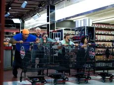 Host Guy Fieri with chefs Tal Sims, Phillip Franklin Lee, David Aflalo, Adela Jung during the start of the shopping of Game 1, Closing Time, Game Day Feast, 2 min shopping time and 30 min cooking time, as seen on Food Network's Guy's Grocery Games, Season 1.