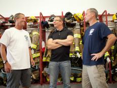Host Robert Irvine, center, meets with firehouse Chief Wade Bradley, left, and President, Dan English, at the Ship Bottom volunteer fire department in Ship Bottom, New Jersey, as seen on Food Network's Restaurant: Impossible, Season 7.
