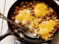 Get Food Network's easy recipe for Baked Eggs with Farmhouse Cheddar and Potatoes, a quick, family-friendly dish for breakfast or dinner.