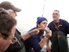 Alex Stein kisses his fish  while the crew of the Brooklyn IV laughs, as seen on Food Network's Worst Cooks in America, Season 4