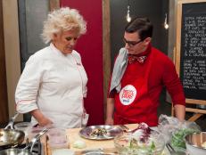 Chef Anne Burrell tasting Michael Haydens attempt to recreate the Chef's Seared Black Sea Bass with bitter greens, fennel,  grapefruit and feta salad, as seen on Food Networks Worst Cooks in America, season 4