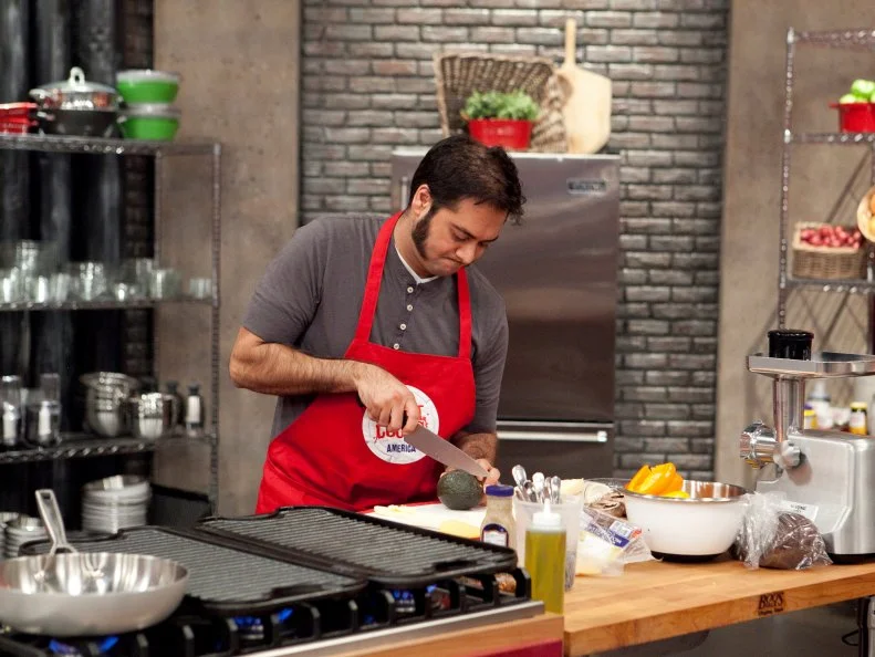 Aadip Desai of the Red Team works on his personal take on the hamburger during the Burger Challenge , as seen on Food Networks Worst Cooks in America, season 4.