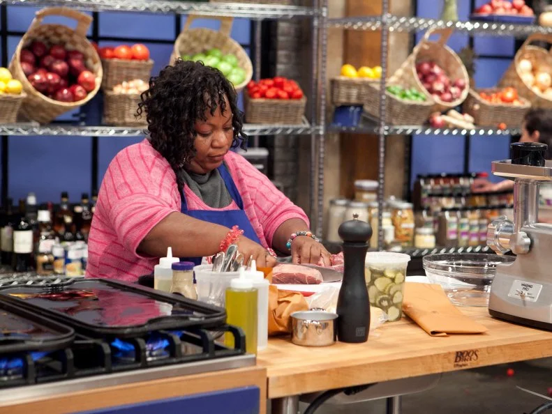 Carla Johnson of the Blue Team works on her personal take on the hamburger during the Burger Challenge , as seen on Food Networks Worst Cooks in America, season 4.