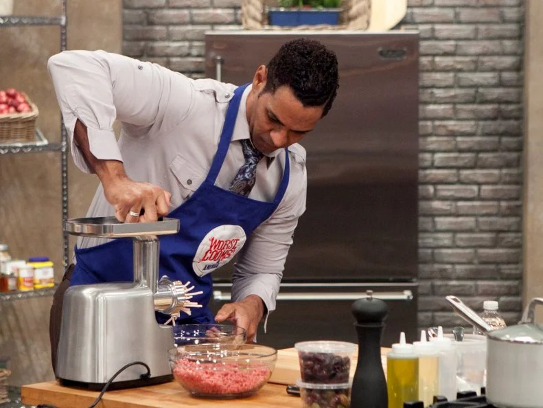 Chet Pourciau of the blue team works on his personal take on the hamburger during the Burger Challenge, as seen on Food Networks Worst Cooks in America, season 4.