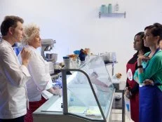Chef Anne Burrell and Chef Bobby Flay use a cooler filled with many different flavors of gelato to test and explain the way flavor combinations can be used in gelato for Carrie Lee Riggins of the Blue team and Rasheeda Brown of the Red team, as seen on Food Networks Worst Cooks in America, Season 4