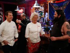Blue Team Leader Chef Bobby Flay and Red Team Leader Chef Anne Burrell  check  in with  biker Andy Animal to see if he's happy with the appetizers the recruits prepared for a gathering of his friends for the "Biker Bites" Challenge.The recruits had to prepare chicken wings based on recipes she and Chef Bobby Flay demonstrated to their recruits plus  an additional appetizer for a party for hungry bikers- a tough crowd to please, as seen on Food Network's Worst Cooks in America, Season 4.