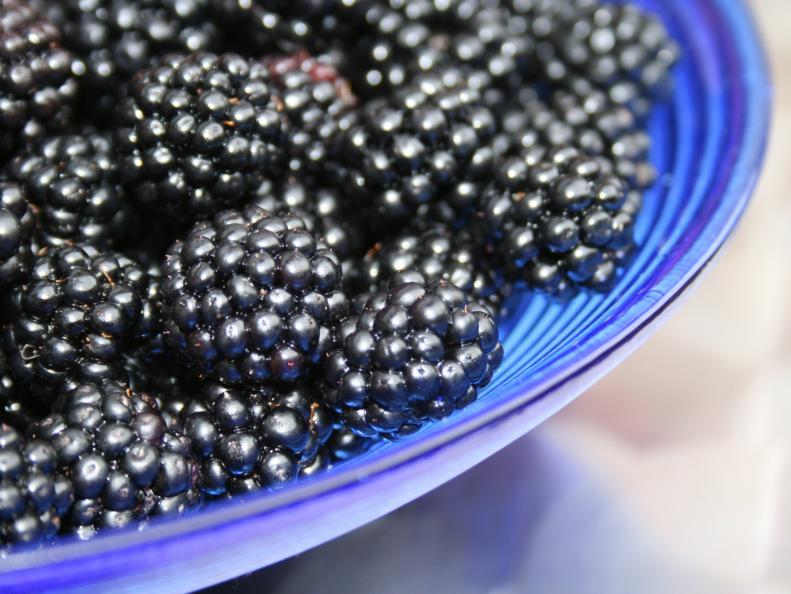 Blackberries in a blue glass bowl