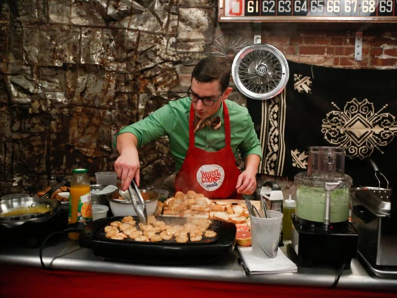 Red Team Recruit Michael Haydin prepares Hot Asian Chicken Wings with ginger, garlic mango, and scallions.   His sauce is a parmesan cheese sauce with garlic and rosemary.  He is also preparing a second appetizer: Grilled Shrimp Crostino with an edamame-goat cheese puree for the "Biker Bites" challenge. The recruits must prepare a variation of Chef Annes Honey-Rosemary Wings with Greek Yogurt, Lemon Garlic Dipping Sauce and an additional appetizer for a party for hungry bikers- a tough crowd to please, as seen on Food Network's Worst Cooks in America, Season 4.