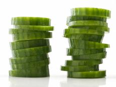 stacked cucumber slices on white