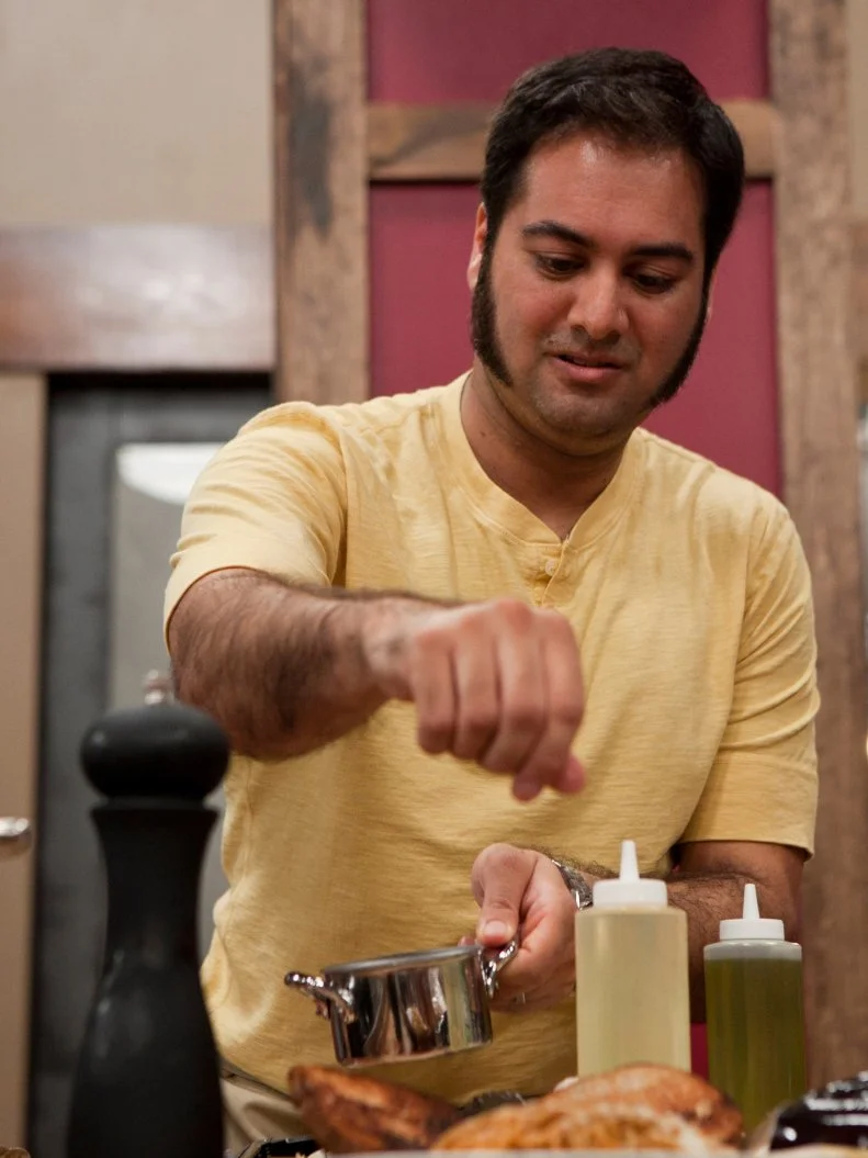 Aadip Desai puts the finishing touches on the pasta he will serve to Chef Anne and Chef Bobby, as seen on Food Network's Worst Cooks in America, Season 4