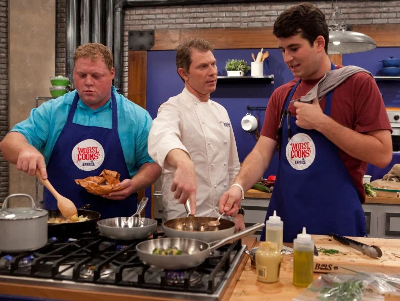 Chef Bobby Flay talks to Alex Steinl of his Blue Team while he is  wokring on Chef Flay's recipe for Tenderloin of beef with a mushroom, mustard and red wine sauce as well as Buttermilk-bacon smashed potatoes or Roasted red potatoes or Yukon gold hash. The recruits were each given sacks of potatoes and a card telling them which pototo recipe they were to make, as seen on Food Networks Worst Cooks in America, Season 4