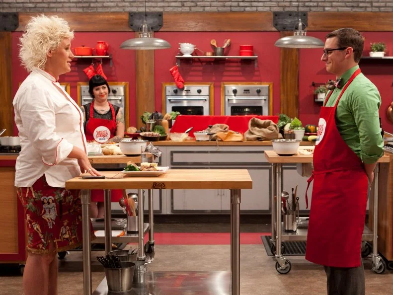 Chef Anne Burrell tasting Michael Hayden's attempt to make Chef Anne's Pan seared pork chops with grape sauce as well as Garlic Yukon gold mashed potatoes or Hash brown potatoes or Herb roasted potatoes. The recruits were each given sacks of potatoes and a card telling them which pototo recipe they were to make, as seen on Food Networks Worst Cooks in America, Season 4