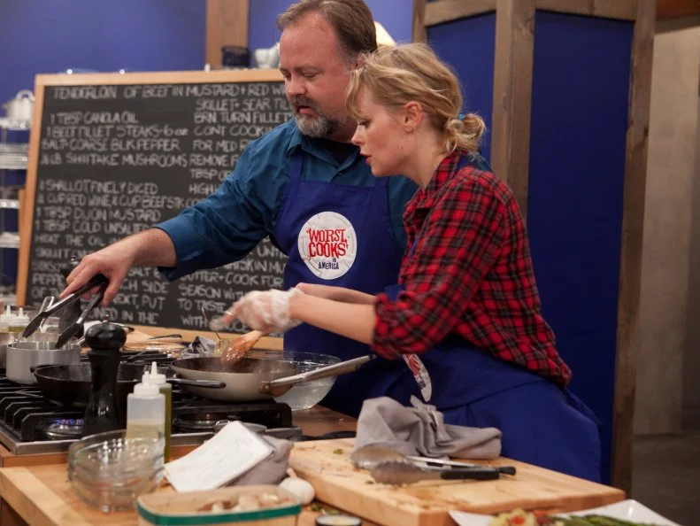 Tim Burger of the Blue team gets some help from Alina Bolshakova as he attempts to make Chef Flay's recipe for Tenderloin of beef with a mushroom, mustard and red wine sauce as well as Buttermilk-bacon smashed potatoes or Roasted red potatoes or Yukon gold hash. The recruits were each given sacks of potatoes and a card telling them which pototo recipe they were to make, as seen on Food Networks Worst Cooks in America, Season 4