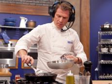 Chef Bobby Flay listens to the blue team (Alina Bolshakova and Chet Pourciau) via headset while they try and describe an unfamiliar dish to the chef that he must replicate by their description alone, as seen on Food Networks Worst Cooks In America, Season 4.