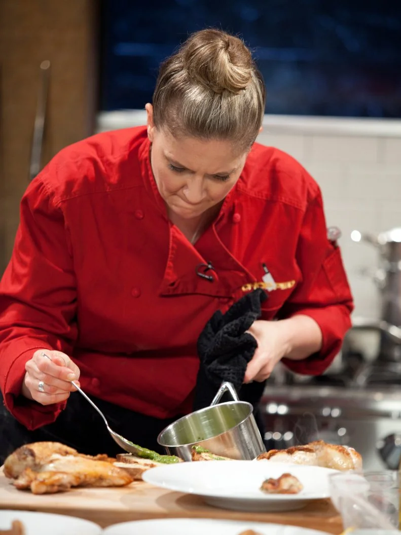 Judge and Chef Amanda Freitag tops bread with a sauce, as seen on Food Network’s Chopped All Stars, Season 14.