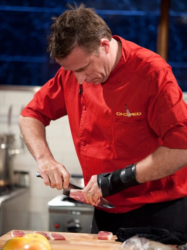Judge and Chef Marc Murphy slices bacon, as seen on Food Network’s Chopped All Stars, Season 14.