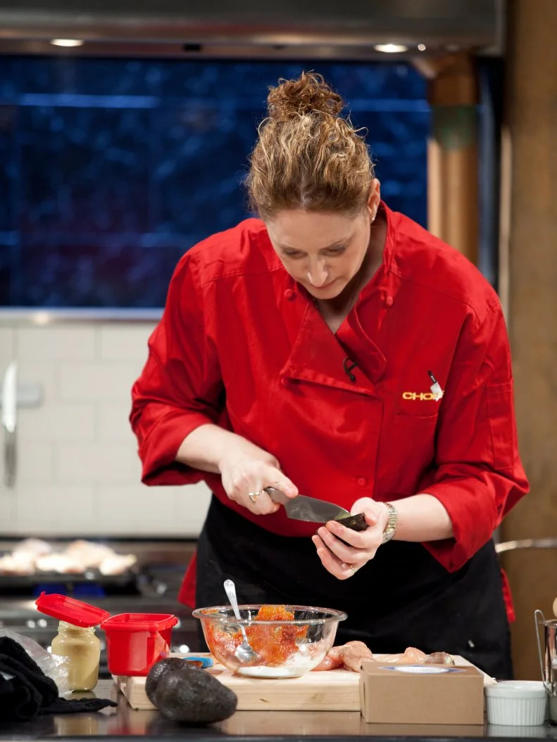 Comedian Judy Gold slices avocado, as seen on Food Network’s Chopped All Stars, Season 14.
