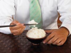 Man with chopsticks and bowl of rice