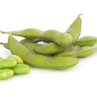 Several edamame soybeans on white