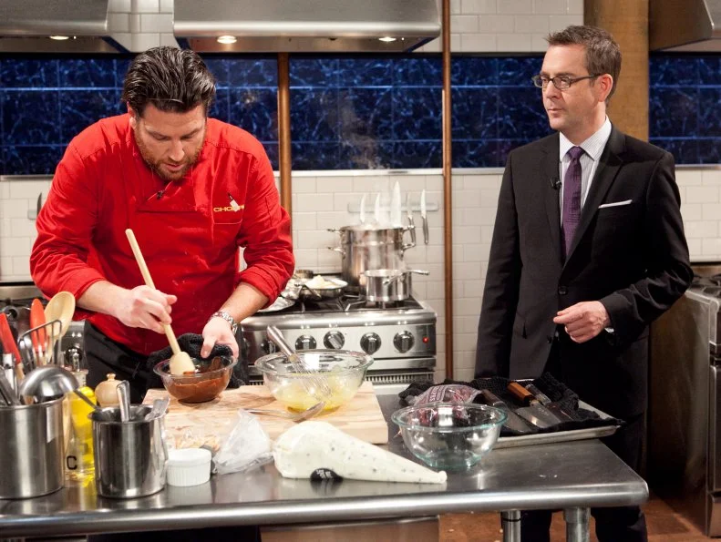 Host Ted Allen talking to All-Star Chef Scott Conant while he works  on his dessert that must include: freeze dried grapes, marrow bones, marcona almonds and cannoli cream,as seen on Food Network's Chopped All-Stars, Season 14.