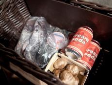 Basket ingredients for the appetizer round, including whole fish, cream soda, and garlic as seen on Food Network’s Chopped All Stars, Season 14.
