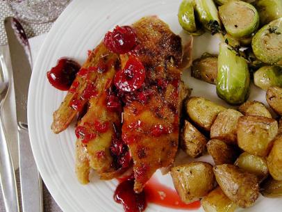 Crisp tender roast duck with cherry rosemary sauce.