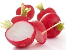 Red radish cut in half on white