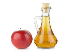 Decanter with vinegar and red apple