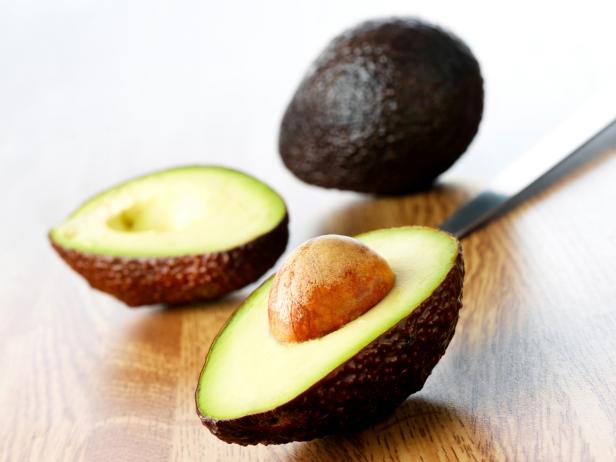 Close-up of fresh avocados on wooden surface