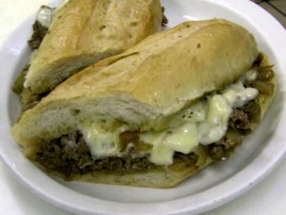 Cheesesteak with cheese and onions.