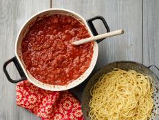 Ree Drummond upgrades store-bought marinara sauce with onions, ground beef, garlic, tomatoes and herbs for a big-batch, semi-homemade spaghetti sauce recipe that is sure to please.