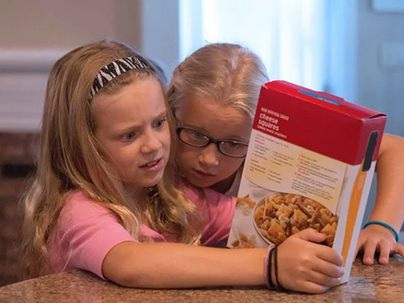 Valentine (left) and Charlotte (right) read a nutrition label