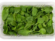 green baby spinach in a clear box