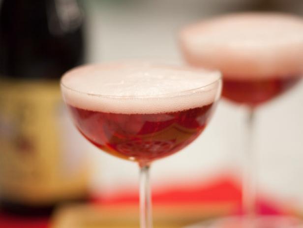 The drink recipe: Champagne and Framboise Lambic (raspberry beer) garnished with a fresh raspberry. Red Velvet prepared by host Geoffrey Zakarian, as seen on Food Network's The Kitchen, Season 1.