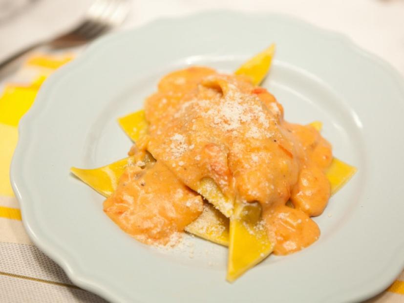 The dish recipe: Wonton-wrapper ravioli filled with minced pot roast, onions, garlic, and parmesan. Served topped with creamy tomato-vodka sauce. A dish of Easy Cheesy Ravioli as seen on Food Network's The Kitchen, Season 1.