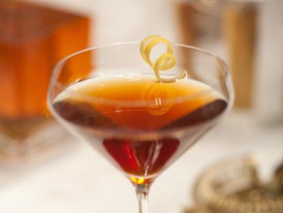 The drink recipe: Rye whiskey, sweet vermouth, dry vermouth, and bitters. Garnished with lemon twist. A Perfect Manhattan as seen on Food Network's The Kitchen, Season 1.