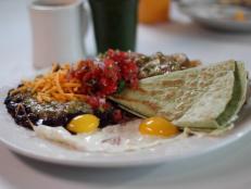 <p>Succotash's eclectic vibe can be seen in everything from the eight-layer citrus cake with teal frosting to their artistic, kitschy decor. For breakfast, locals love the pork hash with sides of black beans and potatoes. Guy says of this spicy plate, "Holy hash, Batman."</p>