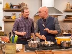 Bobby Flay cooks with Michael Symon as seen on Food Network's Thanksgiving at Bobby's.