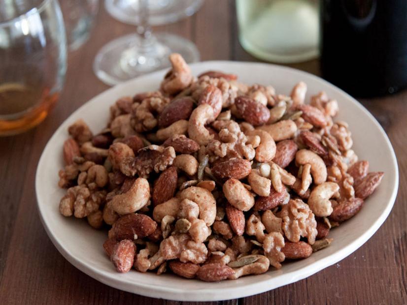 You know what makes a little get-together even more special? Sweet and spicy roasted nuts. It’s a quick and simple recipe that is a really nice touch when you’re welcoming people into your home. Plus, making them ahead of time makes your house smell welcoming, and your neighbors might start wandering over to see what’s going on in your kitchen!

Since I’m the only one in my family that has been to culinary school, I’m typically the one that’s always in the kitchen working on whatever is for dinner. But, these sweet and spicy nuts are so easy that I can delegate them to my husband to put together. The best part is, he feels like he has been super helpful in the kitchen! You can use your favorite assortment of nuts, but I prefer a combination of cashews, walnuts, almonds and pepitas. I use egg whites and water to create a natural binding effect on the nuts with the spice mixture consisting of Spice Islands salt, cayenne pepper and ground cinnamon. The sweet and spicy flavors make for an interesting but welcome surprise as a pre- or post-dinner snack!