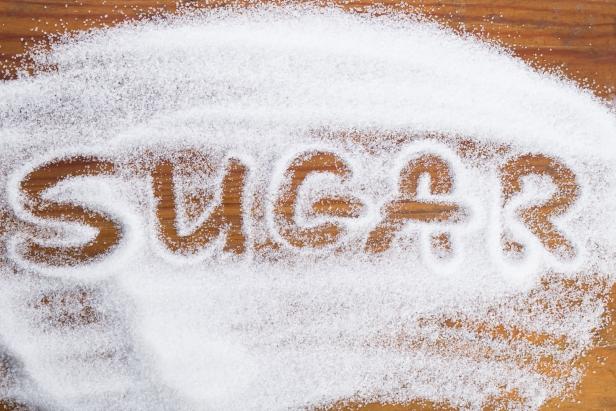 The word 'sugar' written into a pile granulated sugar