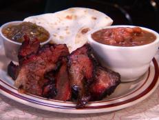 This spot cranks out 30 tons of 'cue a year. Guy is won over by the lamb ribs, saying they “melt in your mouth.” The Pitboss Plate is also a popular pick, as shown on Best. Ever. It comes piled with Central Texas-style brisket, ribs and sausage. Cornbread and sides round out this mouthwatering meal.