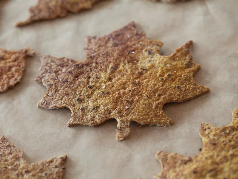leaf chips in autumn colors drying on parchment paper