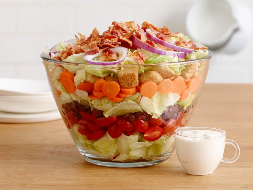 LAYERED BLUE CHEESE AND BACON WEDGE SALAD
Food Network Kitchen
Red Onion, Bacon, Blue Cheese, Sour Cream, Mayonnaise, Worcestershire Sauce, Iceberg
Lettuce, Grape Tomatoes, Kalmata Olives, Carrots, Croutons