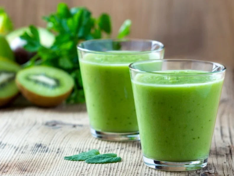 Healthy green Smoothie on wooden table