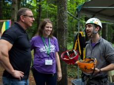 Host Robert Irvine with camp director Kate Walsh and volunteer Oisin Mac Tiarnain (R) at the Ropes Course during a tour of the Double H Ranch in Lake Luzerne, NY, a non for profit organization that provides an overnight camp for kids ages 6-16 with serious or life threatening illnesses and their siblings, during the Holiday Impossible makeover of the enormous dining hall along with the kitchen and the creation of a new food serving process, as seen on Food Network's Restaurant: Impossible, Holiday: Impossible Special.